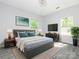 A bedroom with a king bed, large windows, neutral paint, and dark furniture at 108 Graham St, Chester, SC 29706