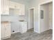 A newly remodeled eat-in kitchen with gray wood flooring and white cabinets at 108 Graham St, Chester, SC 29706