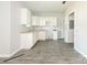 Bright kitchen features white cabinets, gray floors, and a stainless-steel sink at 108 Graham St, Chester, SC 29706