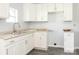 Bright kitchen with stainless steel sink, white cabinets, and light-colored countertops at 108 Graham St, Chester, SC 29706