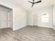 Large open room with gray flooring, featuring an adjacent doorway, and a contemporary ceiling fan at 108 Graham St, Chester, SC 29706