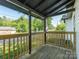 Inviting covered porch with wood railings and a view of the surrounding landscape at 108 Graham St, Chester, SC 29706