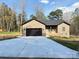 Charming brick home features a modern black garage door and a newly paved driveway at 1112 Sedgewood Ln, Lincolnton, NC 28092