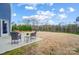 Spacious backyard with a patio featuring outdoor seating, perfect for relaxation and entertaining at 11144 Limehurst Pl, Charlotte, NC 28278