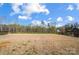 Expansive backyard with potential for landscaping and recreational activities, enclosed by a black fence at 11144 Limehurst Pl, Charlotte, NC 28278