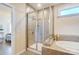 Bathroom view featuring soaking tub and tiled shower at 11144 Limehurst Pl, Charlotte, NC 28278
