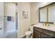 Bathroom featuring modern vanity with granite countertop, framed mirror, and tiled shower at 11144 Limehurst Pl, Charlotte, NC 28278