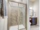 Modern tiled bathroom featuring a glass door shower with modern fixtures at 11144 Limehurst Pl, Charlotte, NC 28278