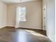 Inviting bedroom with hardwood floors, a window, and neutral walls, perfect for a tranquil retreat at 11144 Limehurst Pl, Charlotte, NC 28278