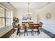 Traditional dining room featuring wood table, chairs, and decorative lighting at 11144 Limehurst Pl, Charlotte, NC 28278
