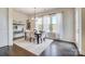 Bright dining room with large windows, decorative chandelier, and elegant furnishings at 11144 Limehurst Pl, Charlotte, NC 28278