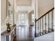 Inviting foyer with natural light, hardwood floors, elegant console table, staircase, and a view of the front door at 11144 Limehurst Pl, Charlotte, NC 28278
