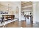 Elegant foyer featuring hardwood floors, a dining area, and a view of the staircase and open-concept living space at 11144 Limehurst Pl, Charlotte, NC 28278