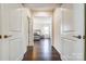 Hallway view into the primary bedroom featuring a comfortable bed and natural light at 11144 Limehurst Pl, Charlotte, NC 28278