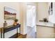 Inviting hallway with hardwood floors and neutral paint, illuminated by natural light from nearby rooms at 11144 Limehurst Pl, Charlotte, NC 28278