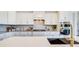 Modern kitchen features sleek white cabinetry, granite countertops, and stainless steel appliances at 11144 Limehurst Pl, Charlotte, NC 28278