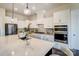 Bright kitchen with stainless steel appliances, white cabinets, large island with a breakfast bar at 11144 Limehurst Pl, Charlotte, NC 28278