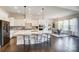 Open kitchen boasts a large island with seating, stainless appliances, and view into dining area at 11144 Limehurst Pl, Charlotte, NC 28278