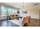 Bright living room with hardwood floors, modern furniture, and large windows offering natural light and outdoor views at 11144 Limehurst Pl, Charlotte, NC 28278