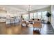 Open-concept living space features hardwood floors, a bright seating area, and a view of the modern kitchen and dining areas at 11144 Limehurst Pl, Charlotte, NC 28278