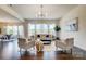 Well-lit living room with hardwood floors, comfortable seating, and a view to the adjacent dining area at 11144 Limehurst Pl, Charlotte, NC 28278