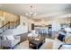 Cozy living room featuring hardwood floors, stylish furniture, and a seamless transition to the modern kitchen at 11144 Limehurst Pl, Charlotte, NC 28278