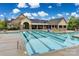Community swimming pool with marked lanes, poolside seating, and a clubhouse in the background on a sunny day at 11144 Limehurst Pl, Charlotte, NC 28278