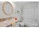 Bathroom featuring a shower-tub combo and updated fixtures at 1205 Scaleybark Rd # A, Charlotte, NC 28209
