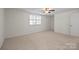 Bright carpeted bedroom with ceiling fan and natural light at 1205 Scaleybark Rd # A, Charlotte, NC 28209
