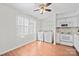 Bright dining area features white cabinets, appliances, and washer/dryer combo with wood flooring at 1205 Scaleybark Rd # A, Charlotte, NC 28209