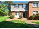 Charming two-story townhouse with a brick facade, black shutters, and a well-maintained front lawn at 1205 Scaleybark Rd # A, Charlotte, NC 28209