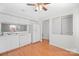 Bright kitchen with white cabinets, appliances, and wood floors at 1205 Scaleybark Rd # A, Charlotte, NC 28209