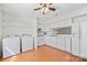 Bright kitchen features white cabinetry, appliances, and washer/dryer combo with wood flooring at 1205 Scaleybark Rd # A, Charlotte, NC 28209