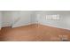 Spacious living room with wood floors, white trim, stairs to upper level, and natural light at 1205 Scaleybark Rd # A, Charlotte, NC 28209
