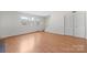 Spacious living room with wood floors, white trim, stairs to upper level, and natural light at 1205 Scaleybark Rd # A, Charlotte, NC 28209
