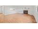 Open living room with wood flooring and brick fireplace at 1205 Scaleybark Rd # A, Charlotte, NC 28209