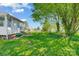 Spacious backyard with mature trees, sunroom, and well-maintained lawn, providing a serene outdoor living space at 130 Atwell Rd, Mt Ulla, NC 28125