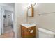 Traditional bathroom featuring a wood vanity, updated lighting and neutral walls at 130 Atwell Rd, Mt Ulla, NC 28125