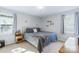 Cozy bedroom with bed, side tables, and natural light streaming through the windows at 130 Atwell Rd, Mt Ulla, NC 28125