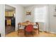 View of dining area with table, chairs and kitchen featuring black appliances in the background at 130 Atwell Rd, Mt Ulla, NC 28125
