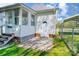Back exterior view, featuring a sunroom, door access, carport, and well-manicured lawn, perfect for outdoor enjoyment and convenience at 130 Atwell Rd, Mt Ulla, NC 28125