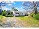 Charming single-story home with a quaint covered parking area surrounded by a well-maintained lawn at 130 Atwell Rd, Mt Ulla, NC 28125