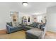 Comfortable living room with a gray sectional sofa, and an open view to the dining and kitchen area at 130 Atwell Rd, Mt Ulla, NC 28125