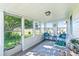 Bright sunroom with lots of windows, gray floors, and comfortable seating, perfect for relaxing and enjoying the view at 130 Atwell Rd, Mt Ulla, NC 28125