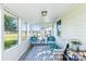 Enclosed sunroom filled with natural light, features durable floors and views of the landscaped yard at 130 Atwell Rd, Mt Ulla, NC 28125