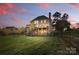 The home's backyard provides ample space and backs to mature trees, offering privacy at 13833 Jonathans Ridge Rd, Mint Hill, NC 28227