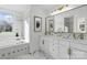 Modern bathroom with marble flooring, double vanity, and soaking tub at 13833 Jonathans Ridge Rd, Mint Hill, NC 28227