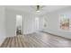 Large bedroom with natural light, luxury vinyl plank floors, and an ensuite bath and walk-in closet at 13833 Jonathans Ridge Rd, Mint Hill, NC 28227