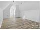 Spacious bonus room with vaulted ceilings, featuring luxury vinyl plank flooring and bright natural light at 13833 Jonathans Ridge Rd, Mint Hill, NC 28227