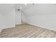 Spacious bonus room with vaulted ceilings, featuring luxury vinyl plank flooring and bright natural light at 13833 Jonathans Ridge Rd, Mint Hill, NC 28227